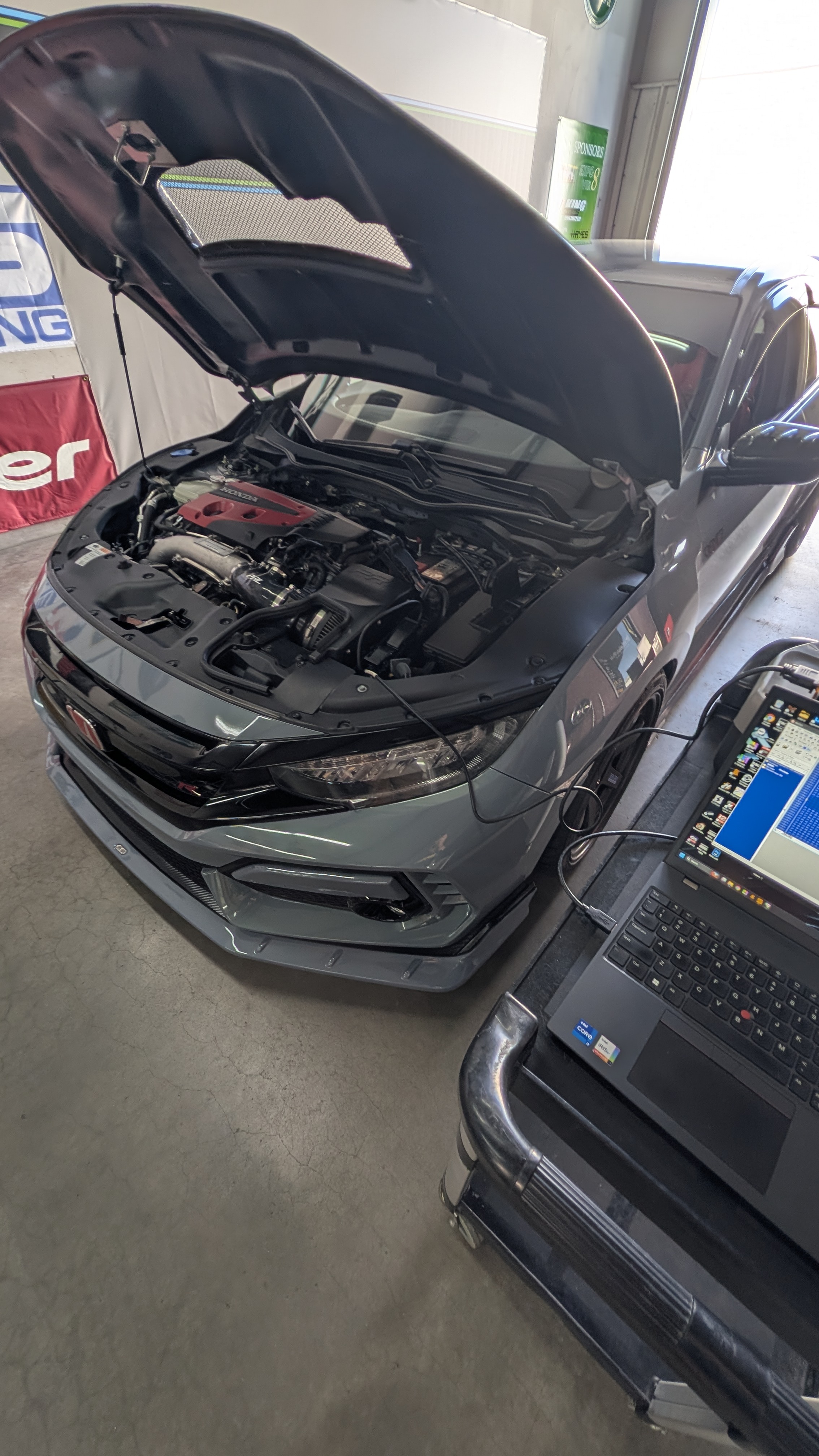 Honda Civic Type R in the IMW shop with a calibration laptop connected